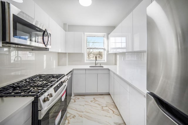 kitchen with white cabinetry, sink, and appliances with stainless steel finishes