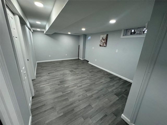 basement with dark hardwood / wood-style flooring