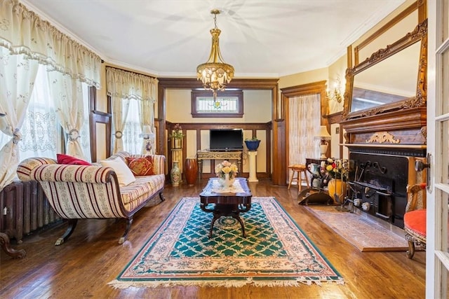 sitting room featuring hardwood / wood-style flooring, ornamental molding, and radiator