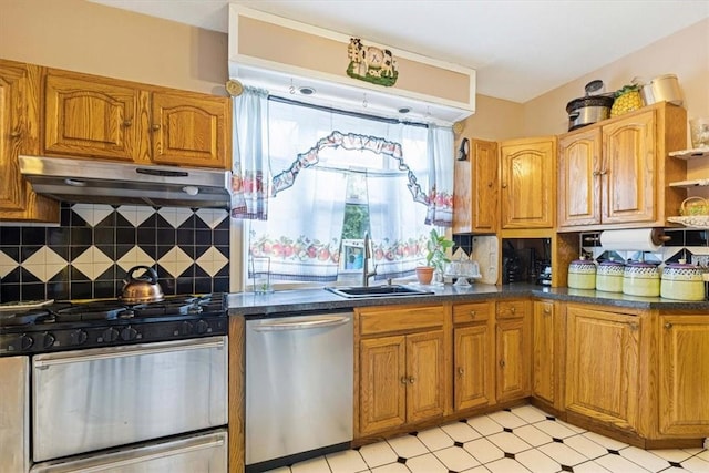 kitchen featuring decorative backsplash, sink, and appliances with stainless steel finishes