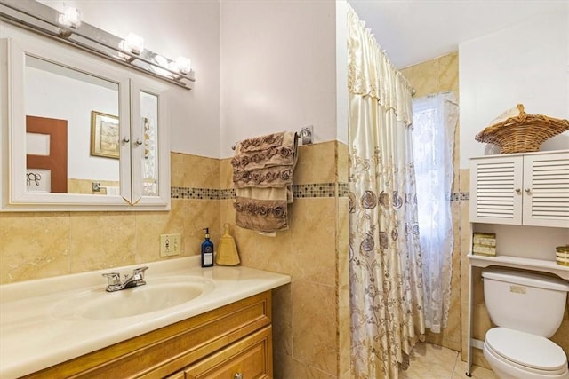 bathroom featuring tile patterned floors, toilet, vanity, tile walls, and a shower with shower curtain