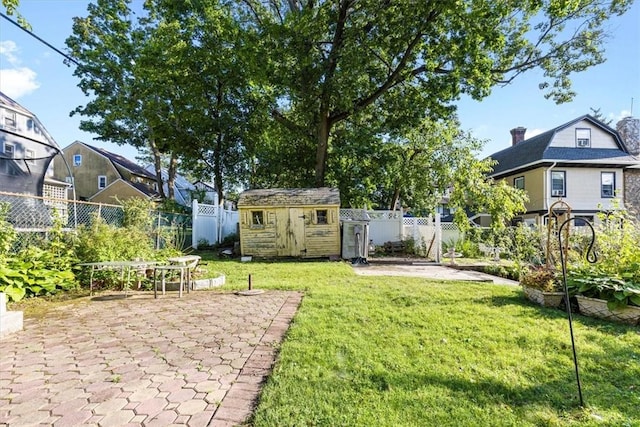 view of yard featuring a storage unit and a patio