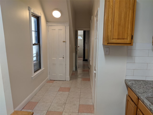 hallway featuring light tile patterned floors