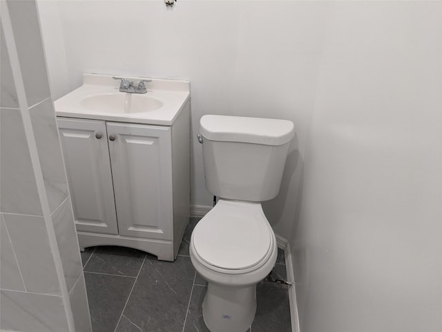 bathroom featuring tile patterned floors, vanity, and toilet