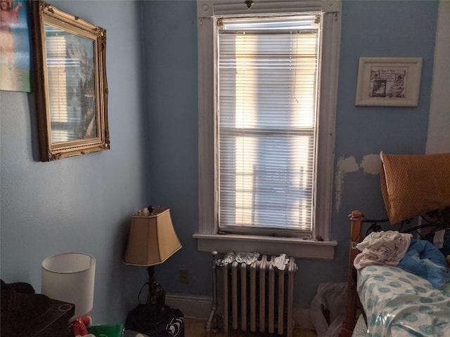 interior space featuring radiator heating unit and multiple windows