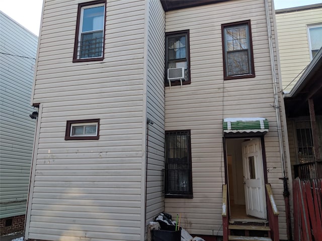 rear view of house featuring cooling unit