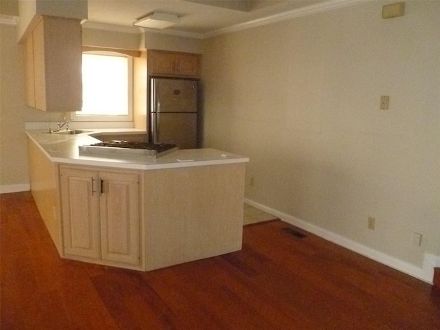 kitchen featuring gas cooktop, light brown cabinetry, refrigerator, sink, and light hardwood / wood-style floors