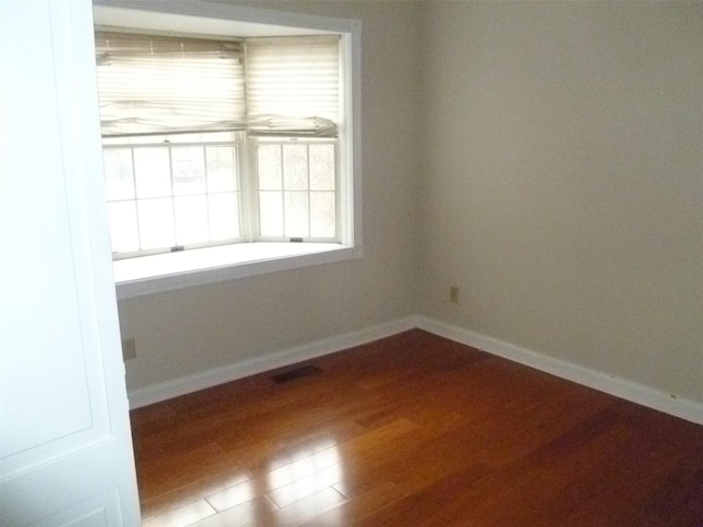 empty room featuring hardwood / wood-style flooring