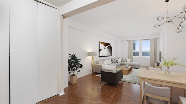 living room featuring a chandelier and dark parquet floors