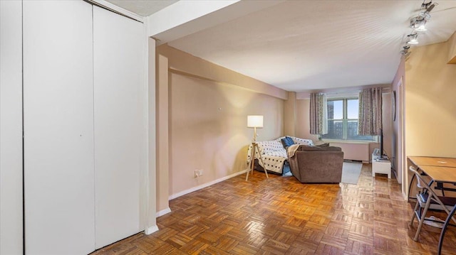 sitting room featuring dark parquet flooring