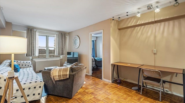 living area featuring parquet flooring