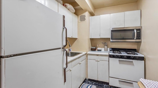 kitchen with white cabinets and white appliances