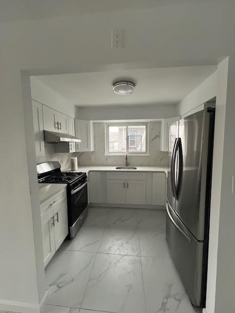 kitchen featuring white cabinets, appliances with stainless steel finishes, and sink