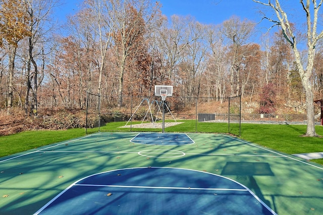 view of basketball court featuring a yard