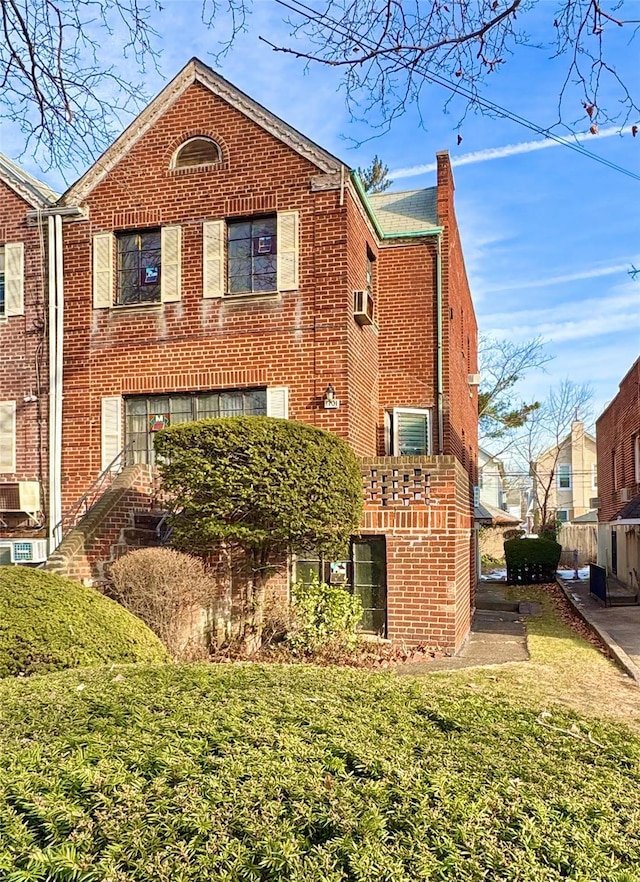 rear view of house featuring a lawn