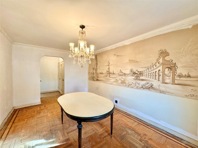 dining room featuring parquet floors, a chandelier, and ornamental molding