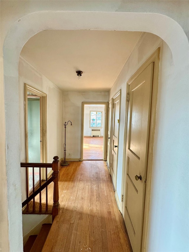 corridor with hardwood / wood-style floors