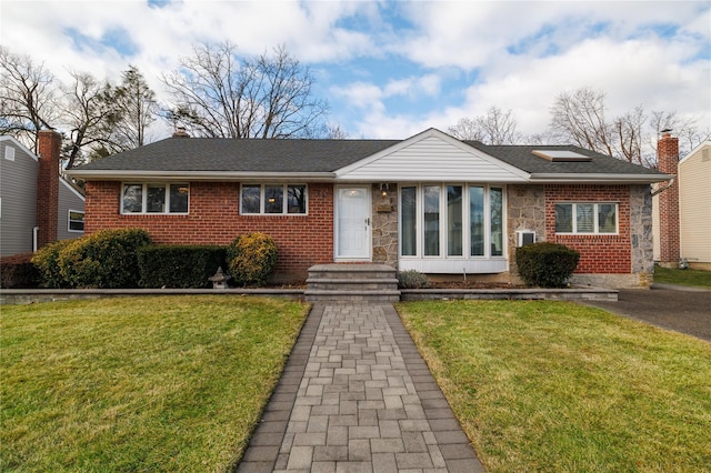 view of front of property featuring a front yard and a sunroom