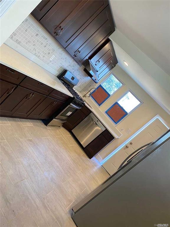 kitchen with dark brown cabinets and stainless steel dishwasher