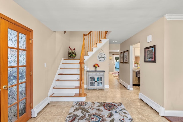 staircase featuring a baseboard radiator and tile patterned flooring