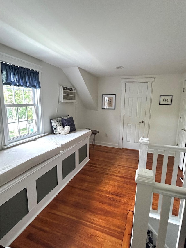 interior space featuring dark hardwood / wood-style flooring and a wall mounted AC