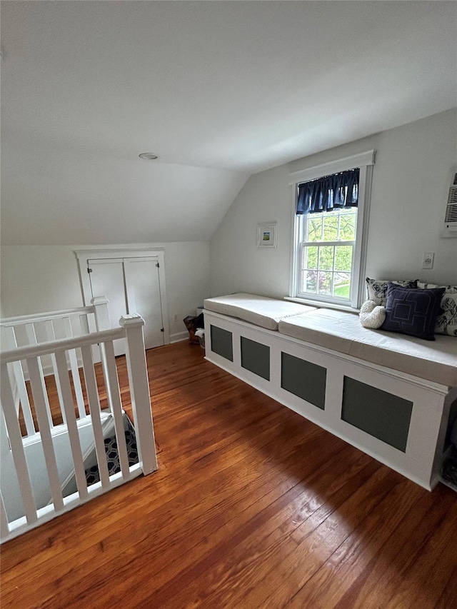 additional living space featuring wood-type flooring and lofted ceiling