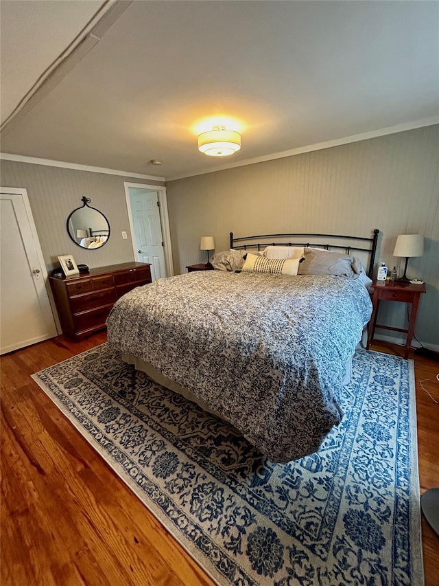 bedroom featuring dark hardwood / wood-style floors and ornamental molding