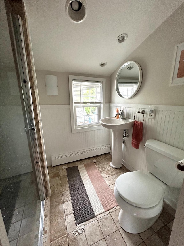 bathroom featuring a baseboard radiator, toilet, and a shower with shower door