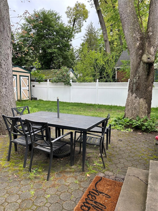 view of yard featuring a patio area and a storage shed