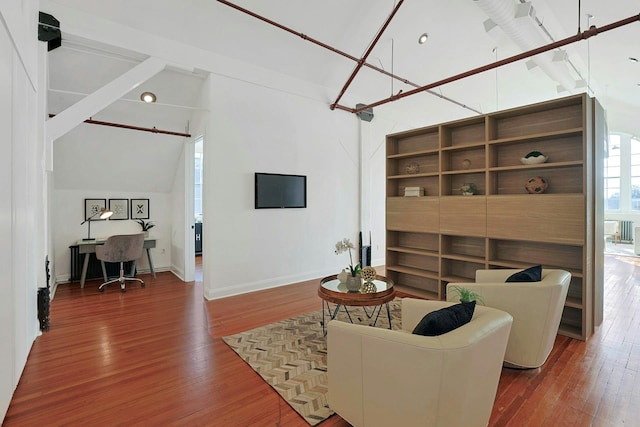 living room featuring built in features, high vaulted ceiling, and wood-type flooring