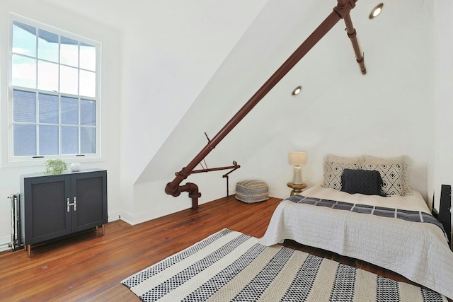 bedroom with dark hardwood / wood-style floors