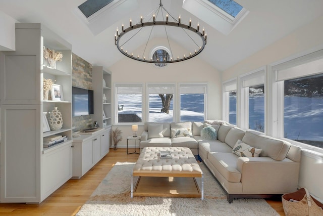 sunroom with lofted ceiling with skylight and a notable chandelier