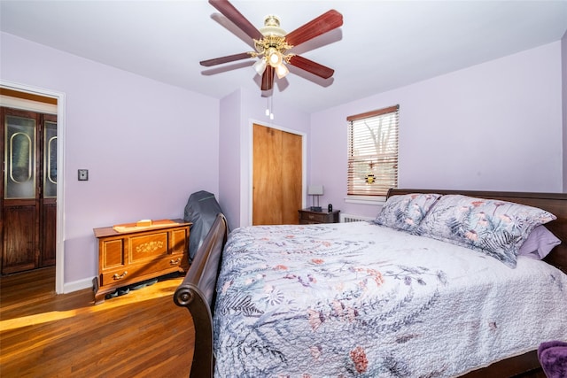 bedroom featuring ceiling fan, dark wood-type flooring, and a closet