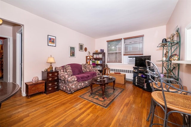 living room with radiator and wood-type flooring