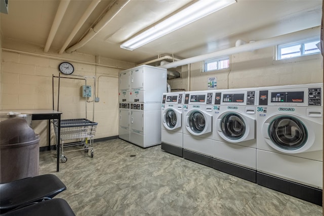 laundry room with stacked washing maching and dryer and washing machine and clothes dryer