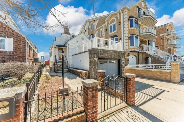 view of front of home featuring a garage and central air condition unit