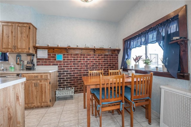 tiled dining area featuring radiator heating unit