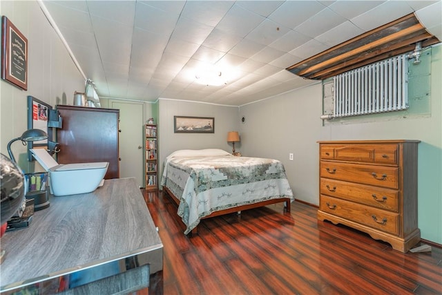 bedroom with dark wood-type flooring