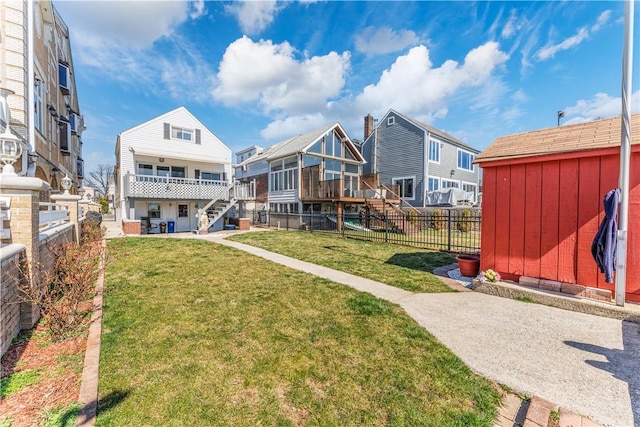 back of property featuring a storage unit and a yard