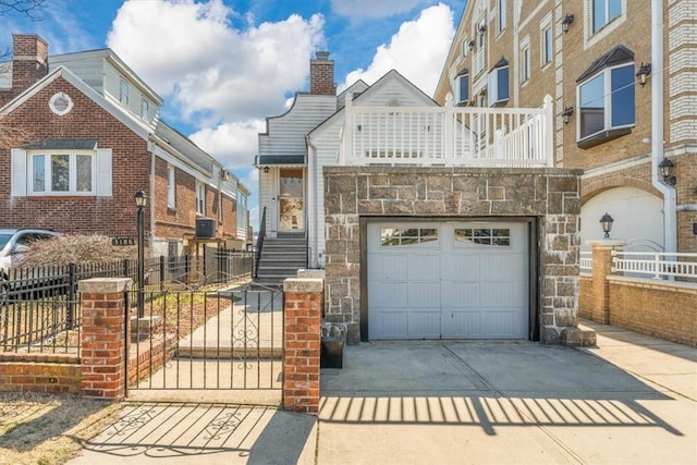 view of front of property featuring a balcony and central AC