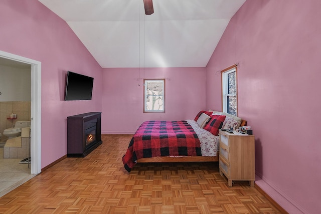 bedroom featuring ceiling fan, lofted ceiling, light parquet flooring, and ensuite bath