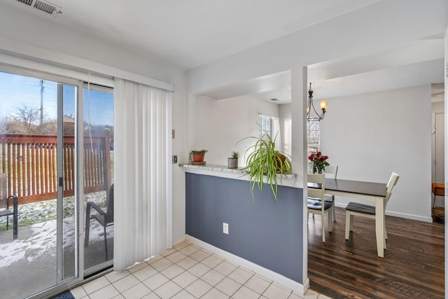 kitchen featuring hanging light fixtures, an inviting chandelier, and light tile patterned flooring