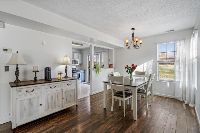 dining area featuring an inviting chandelier and dark hardwood / wood-style flooring