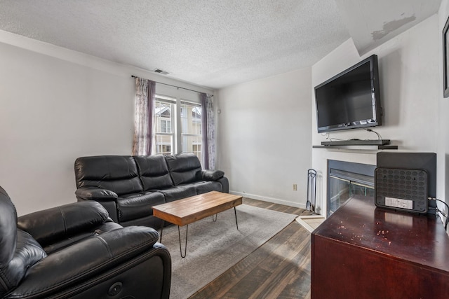 living room featuring a textured ceiling and hardwood / wood-style flooring