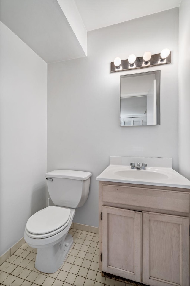 bathroom featuring toilet, tile patterned floors, and vanity