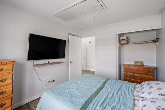 bedroom with a closet and dark hardwood / wood-style flooring