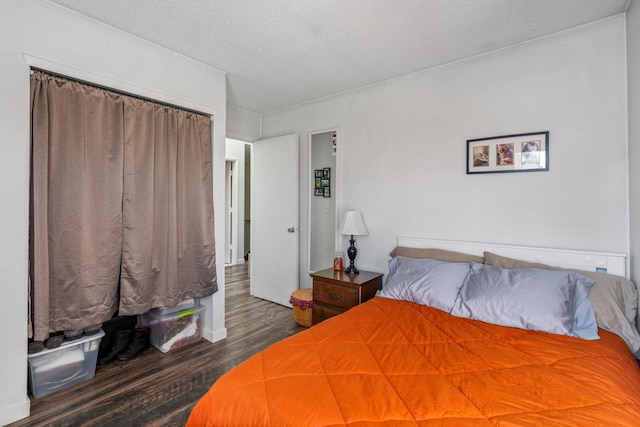 unfurnished bedroom featuring a textured ceiling and dark hardwood / wood-style floors