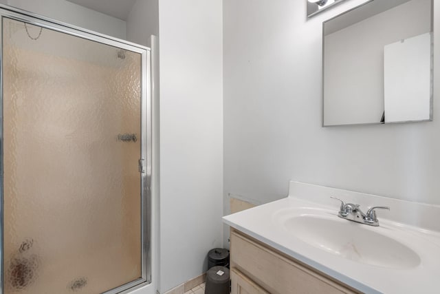 bathroom featuring vanity and a shower with shower door