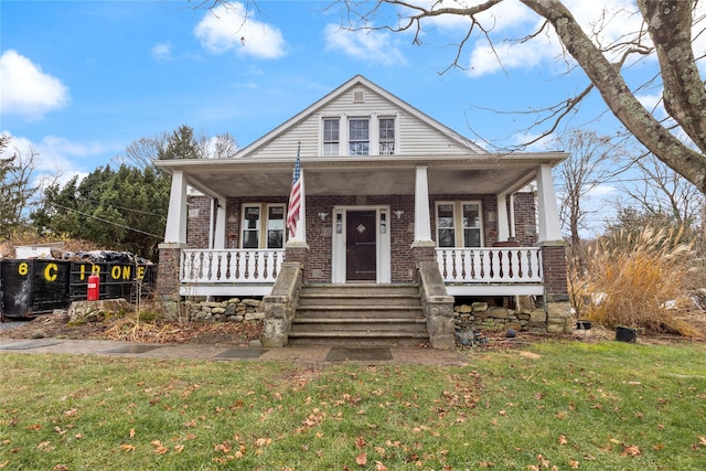 view of front of house with a front yard and a porch