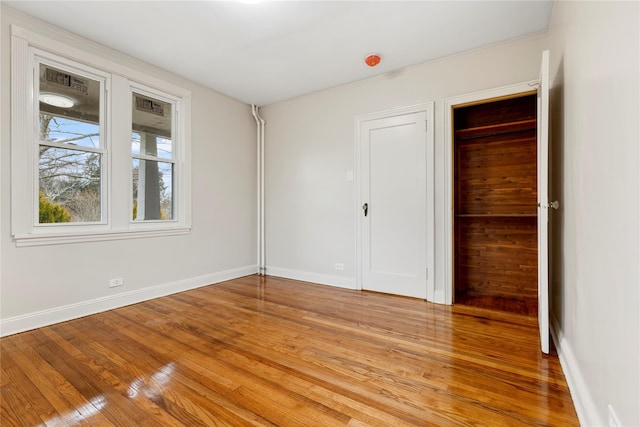 unfurnished bedroom with hardwood / wood-style flooring and a closet